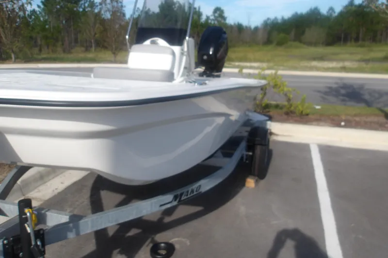 Slide: The Image of 2026 Mako Pro Skiff 13 CC boat on trailer in parking lot. - 13