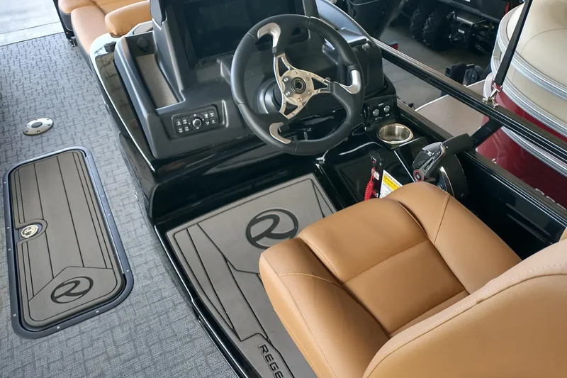 Slide: The Image of 2026 Regency 230 DL boat interior with tan seating and modern steering console. - 3