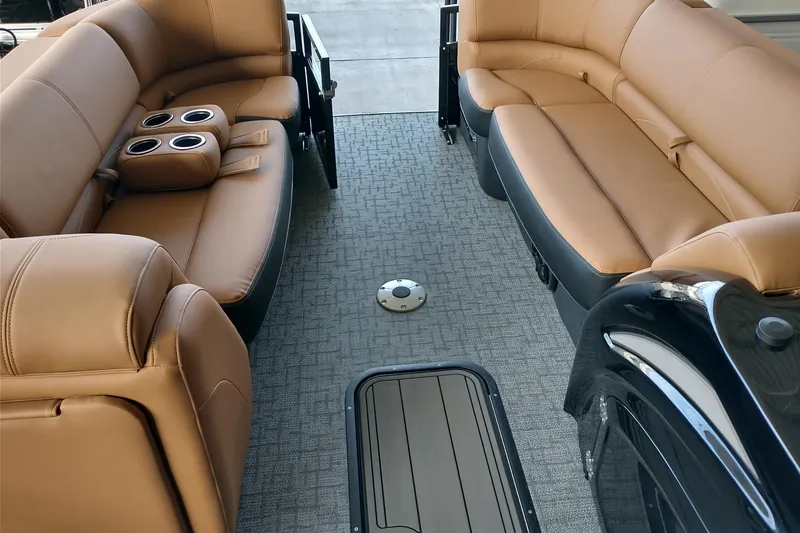 Slide: The Image of Luxurious interior of 2026 Regency 230 DL boat with tan leather seating and cup holders. - 7