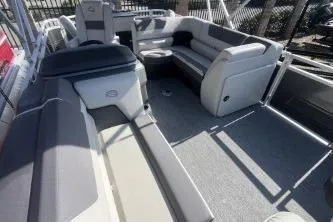 Slide: The Image of 2026 Sun Tracker Fishin' Barge 20 DLX interior with spacious seating and modern design. - 7