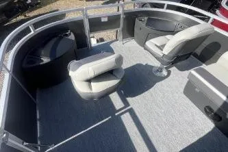Slide: The Image of 2026 Sun Tracker Fishin' Barge 20 DLX interior with seating and storage. - 6