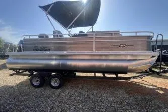 Slide: The Image of 2026 Sun Tracker Fishin' Barge 20 DLX pontoon boat with canopy on trailer. - 2