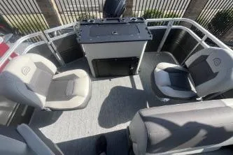 Slide: The Image of 2026 Sun Tracker Fishin' Barge 20 DLX interior with seating and control console. - 4