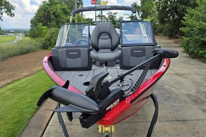 Slide: The Image of 2026 Tracker Pro Guide V-175 Combo boat with Minn Kota motor, parked on a driveway. - 2