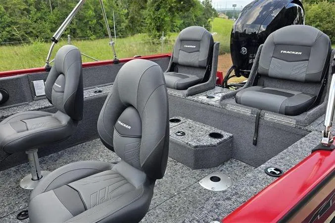 Slide: The Image of 2026 Tracker Pro Guide V-175 Combo boat interior with gray seating and carpeted flooring. - 7