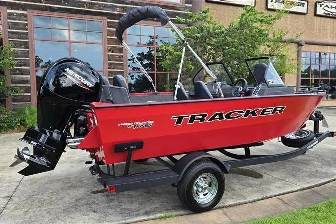 Slide: The Image of 2026 Tracker Pro Guide V-175 Combo boat, red exterior, on trailer, parked outdoors. - 6