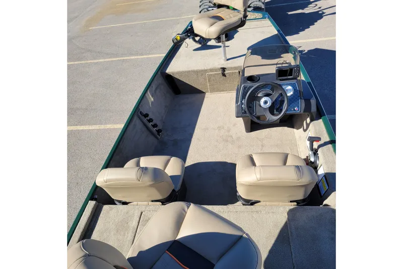 Slide: The Image of 2026 Tracker Bass Tracker Classic Limited boat interior with beige seats and steering console. - 39