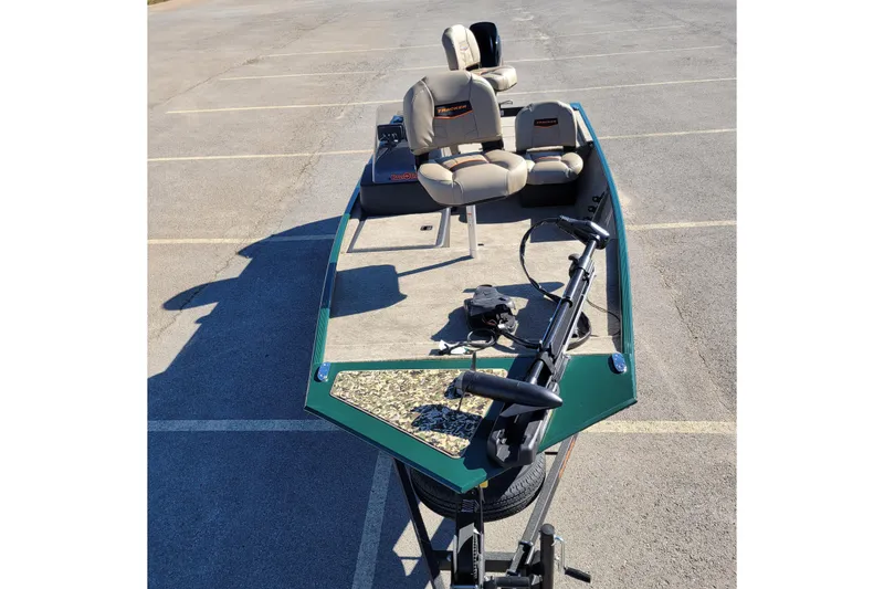Slide: The Image of 2026 Tracker Bass Tracker Classic Limited boat in parking lot, featuring beige seats and green trim. - 41