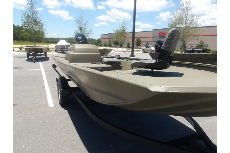 Slide: The Image of 2026 Tracker Grizzly 1754 SC boat in parking lot under blue sky. - 14