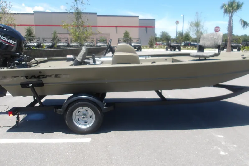 The Image of 2026 Tracker Grizzly 1754 SC boat on trailer in parking lot. - 2
