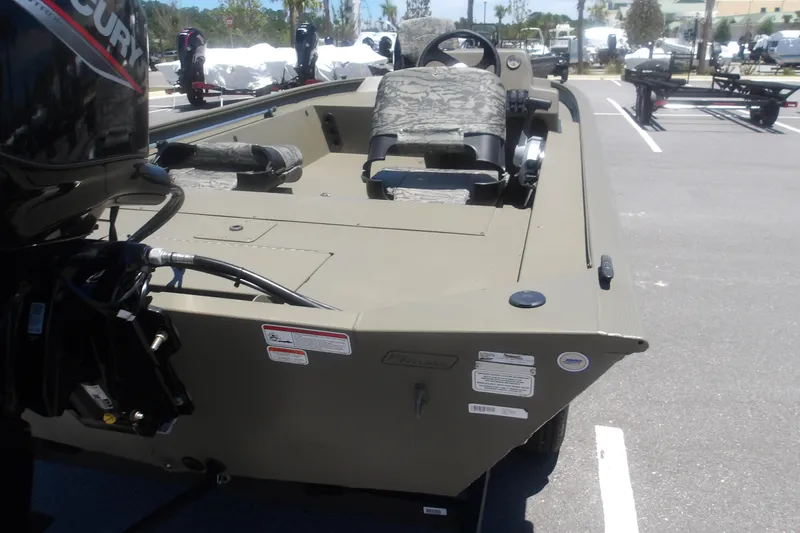 Slide: The Image of 2026 Tracker Grizzly 1754 SC boat with Mercury engine in parking lot. - 5