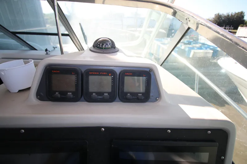 Slide: The Image of 2008 Robalo R305 Walkaround dashboard with tachometers and speed fuel gauges. - 10