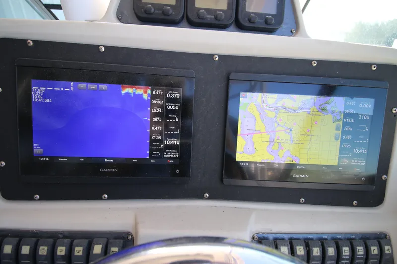 Slide: The Image of Garmin navigation displays on 2008 Robalo R305 Walkaround boat dashboard. - 11