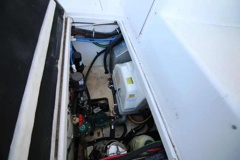 Slide: The Image of Engine compartment of 2008 Robalo R305 Walkaround boat, showcasing mechanical components. - 12