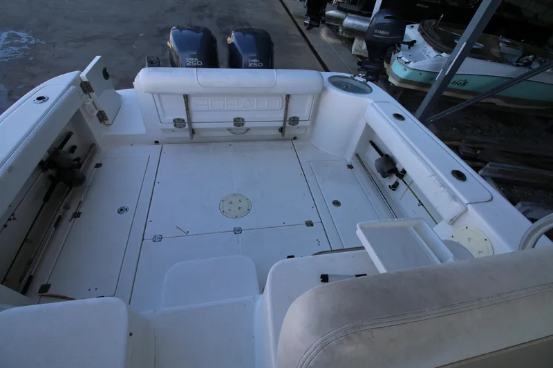 Slide: The Image of 2008 Robalo R305 Walkaround boat deck with twin outboard engines. - 13