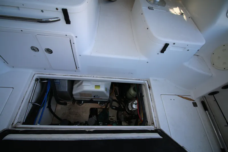 Slide: The Image of 2008 Robalo R305 Walkaround engine compartment with open hatch, showcasing interior components. - 14