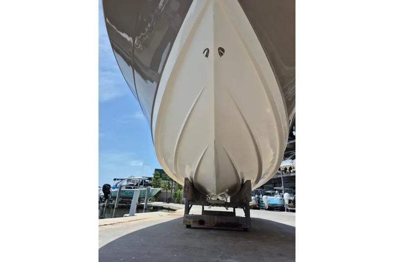 Slide: The Image of 2008 Robalo R305 Walkaround boat hull on trailer, dockside view. - 2