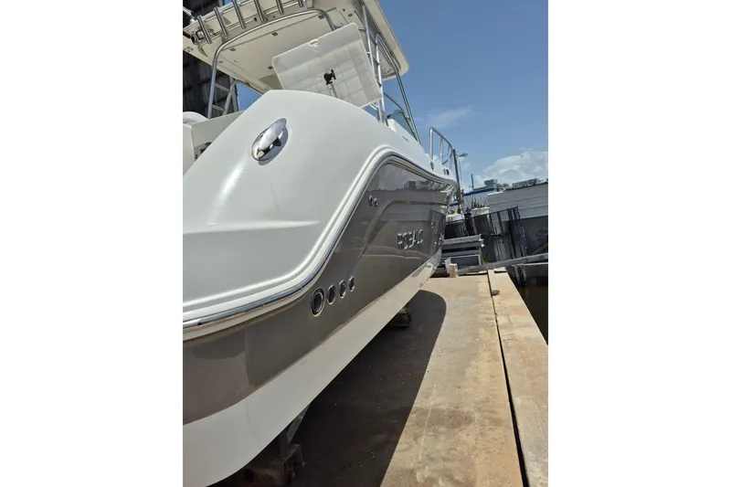 Slide: The Image of 2008 Robalo R305 Walkaround boat on dock, showcasing sleek design and sturdy construction. - 37