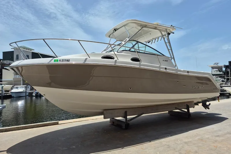 The Image of 2008 Robalo R305 Walkaround boat on display at a marina under clear skies. - 1