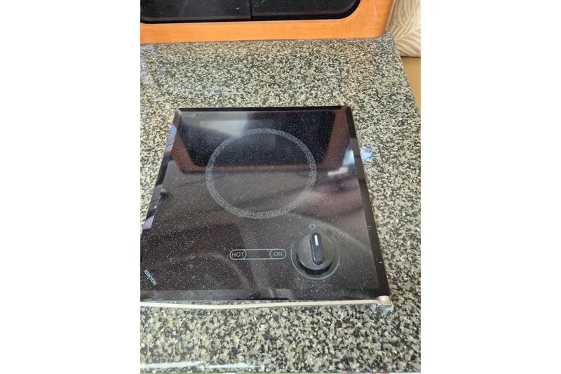 Slide: The Image of Electric stove on granite countertop in 2008 Robalo R305 Walkaround boat kitchen. - 21