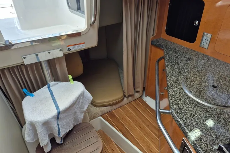 Slide: The Image of 2008 Robalo R305 Walkaround cabin interior with kitchenette and sleeping area. - 15