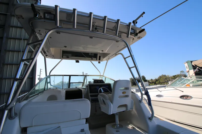 Slide: The Image of 2008 Robalo R305 Walkaround boat interior with helm and seating area. - 6