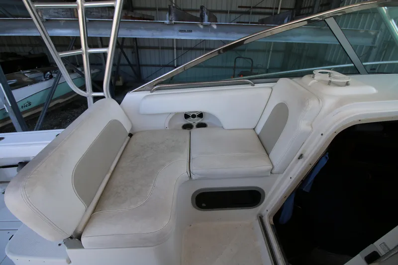 Slide: The Image of 2008 Robalo R305 Walkaround boat interior seating area in a storage facility. - 7