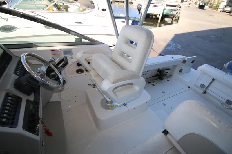 Slide: The Image of 2008 Robalo R305 Walkaround boat cockpit with steering wheel and seating. - 8