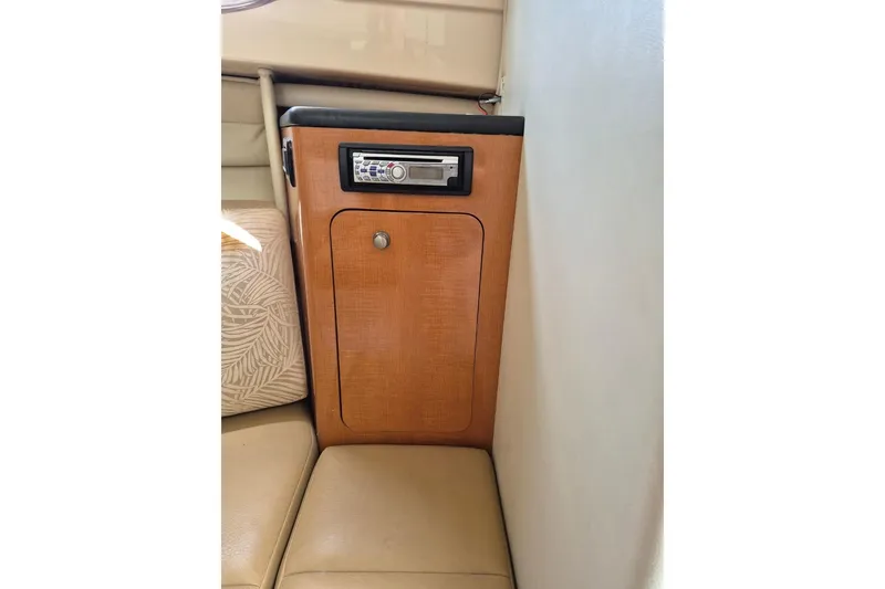 Slide: The Image of 2008 Robalo R305 Walkaround cabin interior with wood panel and stereo system. - 17