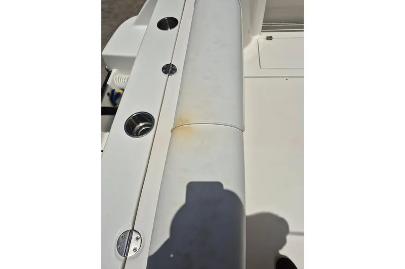 Slide: The Image of 2008 Robalo R305 Walkaround boat interior with cup holders and seating area. - 8
