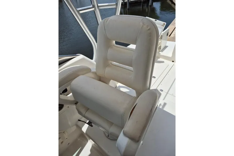 Slide: The Image of White captain's chair on 2008 Robalo R305 Walkaround boat, dockside view. - 11