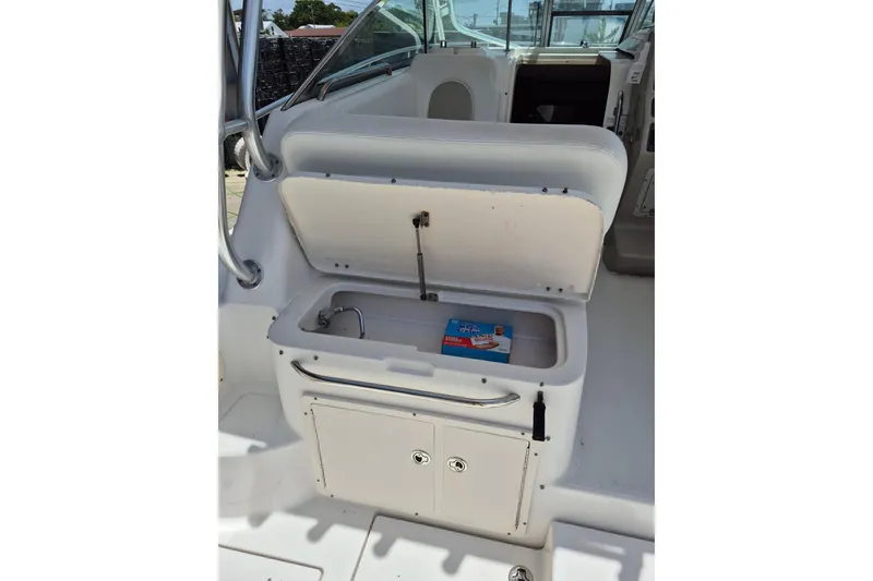 Slide: The Image of 2008 Robalo R305 Walkaround boat interior with open storage compartment. - 28