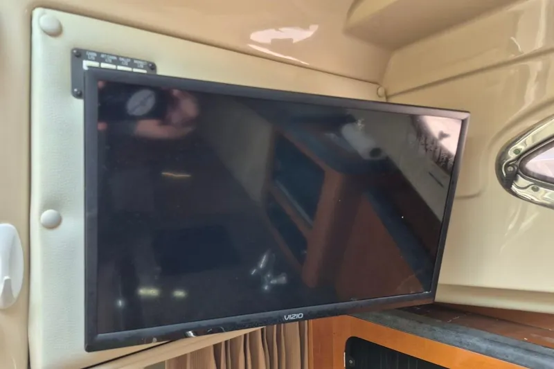 Slide: The Image of Flat-screen TV inside 2008 Robalo R305 Walkaround boat cabin. - 23