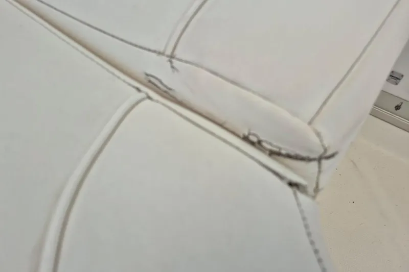 Slide: The Image of Close-up of worn upholstery on 2008 Robalo R305 Walkaround boat seat. - 10