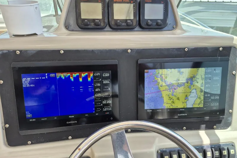Slide: The Image of Dashboard of 2008 Robalo R305 Walkaround with Garmin navigation displays. - 30