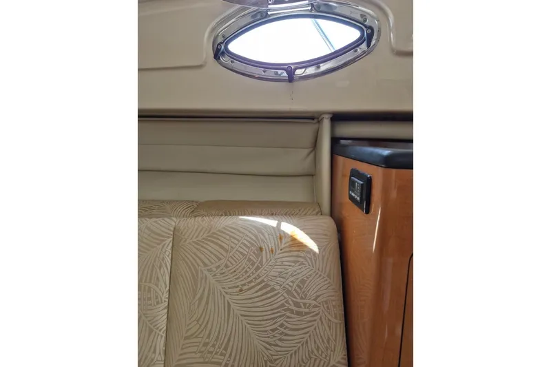 Slide: The Image of Interior of 2008 Robalo R305 Walkaround boat with patterned upholstery and porthole window. - 18
