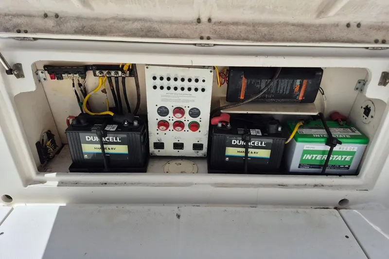 Slide: The Image of Electrical compartment of a 2008 Robalo R305 Walkaround with marine batteries and control panel. - 29