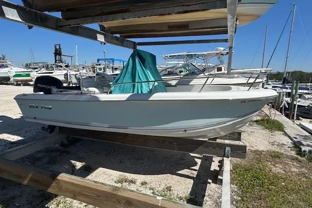 The Image of 2006 Sea Pro 196 Center Console boat on dry dock, surrounded by other vessels. - 1