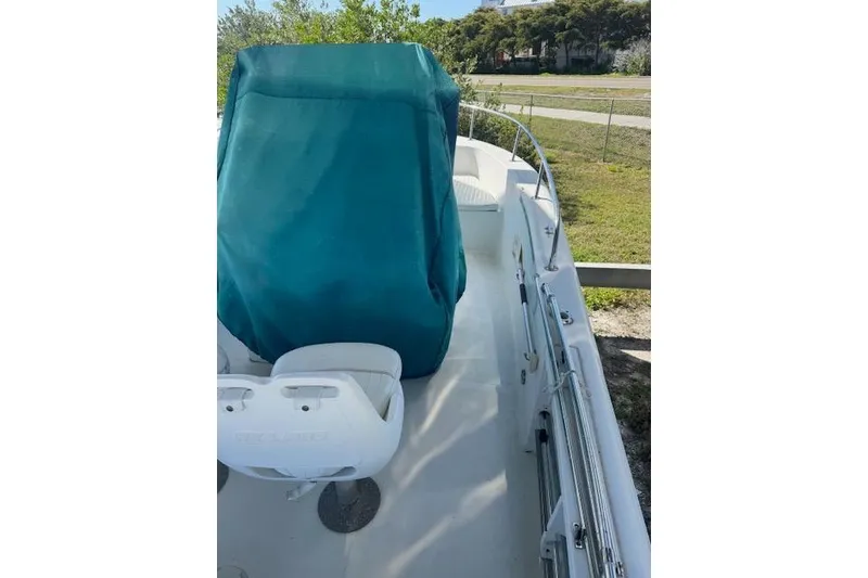 Slide: The Image of 2006 Sea Pro 196 Center Console boat with covered seating, docked outdoors. - 10