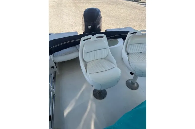 Slide: The Image of 2006 Sea Pro 196 Center Console boat interior with white seating and Mercury engine. - 12