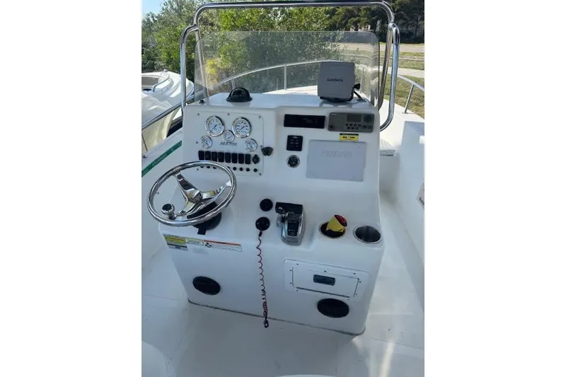 Slide: The Image of 2006 Sea Pro 196 Center Console boat dashboard with steering wheel and controls. - 15