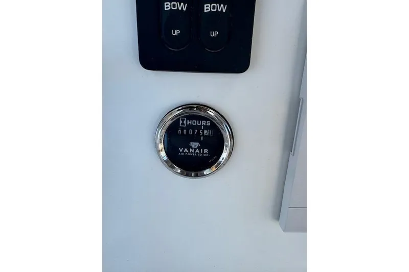 Slide: The Image of Close-up of a 2006 Sea Pro 196 Center Console hour meter and bow control switches. - 19