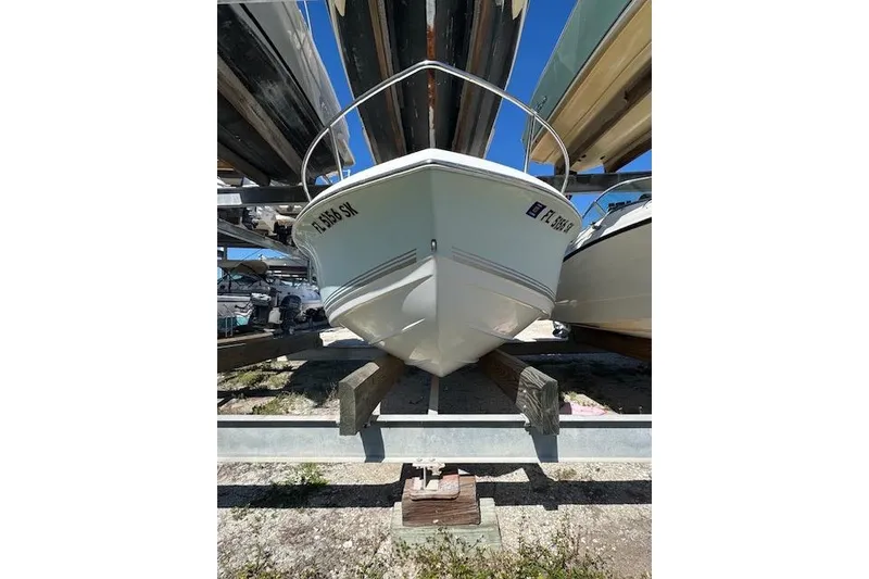 The Image of 2006 Sea Pro 196 Center Console boat stored on a rack outdoors. - 2