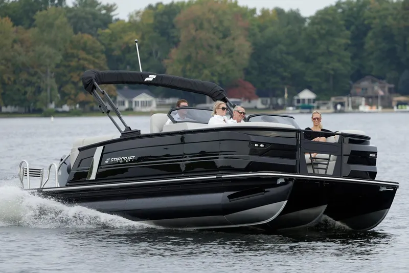 Slide: The Image of Manufacturer Provided Image: Manufacturer Provided Image: 2026 Starcraft RX 23 DL pontoon boat cruising on a lake with passengers. - 5