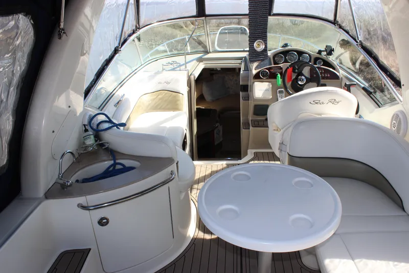 Slide: The Image of Interior of 2006 Sea Ray Sundancer 260 boat with helm, seating, and small sink. - 12