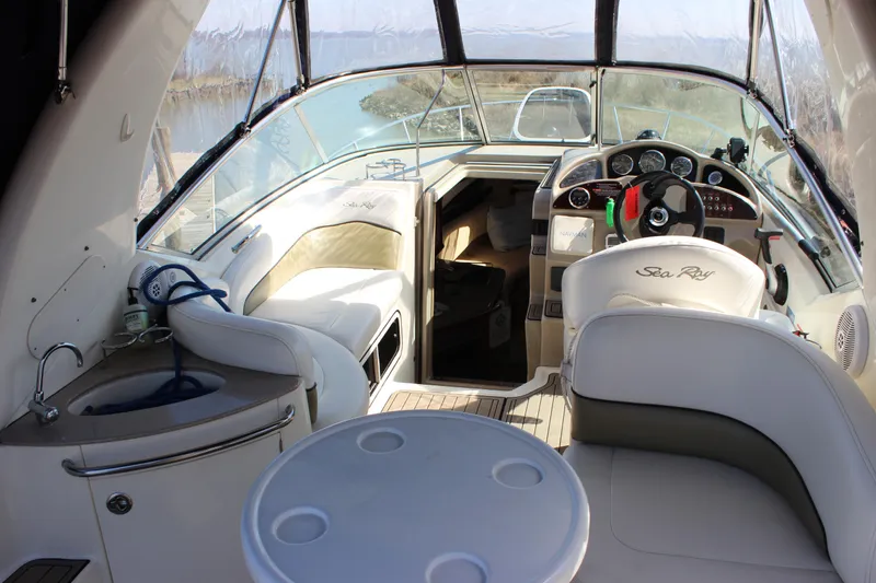 Slide: The Image of Interior of a 2006 Sea Ray Sundancer 260 boat, featuring helm and seating area. - 13
