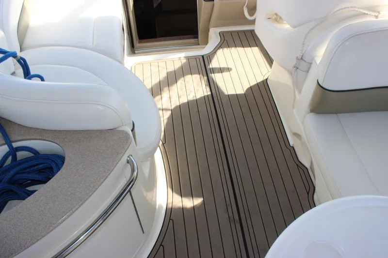 Slide: The Image of Interior of 2006 Sea Ray Sundancer 260 with white seating and wooden flooring. - 14