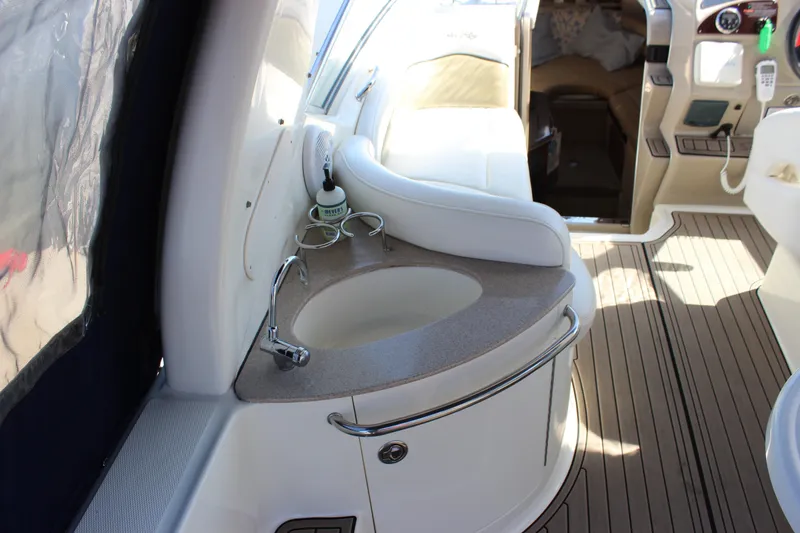 Slide: The Image of 2006 Sea Ray Sundancer 260 interior with sink and seating area. - 15