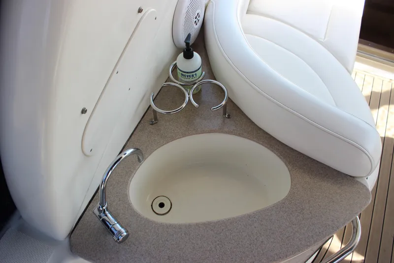 Slide: The Image of 2006 Sea Ray Sundancer 260 boat interior with sink and seating area. - 16