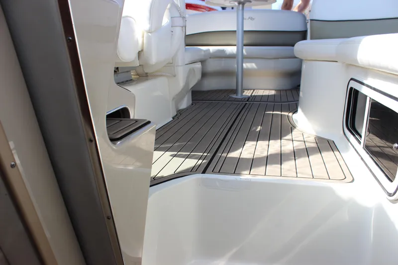 Slide: The Image of Interior view of 2006 Sea Ray Sundancer 260 boat with sleek seating and wooden flooring. - 22